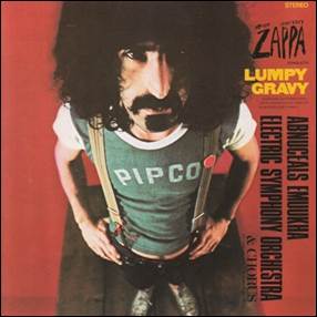 A person with long black hair and a mustache
Description automatically generated
