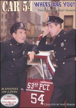 A person in uniform leaning on a car
Description automatically generated