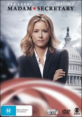 A person in a suit with her arms crossed
Description automatically generated