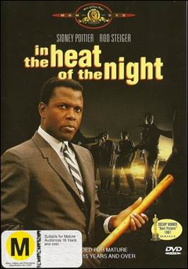 A person in a suit holding a bat
Description automatically generated