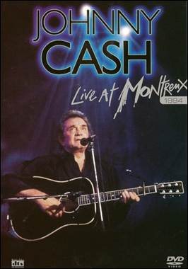 A person holding a guitar and singing

Description automatically generated