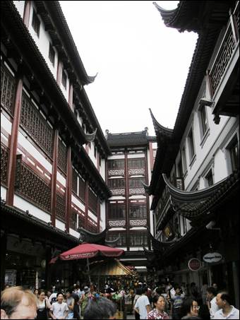 A street with buildings and umbrellas

AI-generated content may be incorrect.