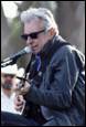 A person with sunglasses and a microphone

Description automatically generated with low confidence