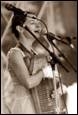 A picture containing concert, microphone, person, music artist

Description automatically generated