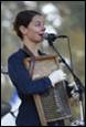 A person holding an accordion

Description automatically generated with low confidence