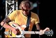 A person playing a guitar

Description automatically generated