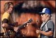A person holding a guitar and another person holding a guitar

Description automatically generated with low confidence