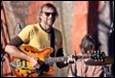 A person playing a guitar

Description automatically generated with medium confidence
