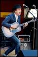 A person playing guitar on stage

Description automatically generated with medium confidence