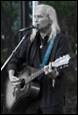 A person playing guitar and singing into a microphone

Description automatically generated with low confidence