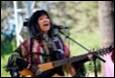 A person singing and playing a guitar

Description automatically generated with medium confidence