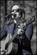 A person holding a guitar and singing

Description automatically generated with low confidence