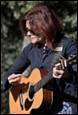 A person playing a guitar

Description automatically generated with medium confidence