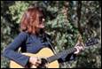 A person playing a guitar

Description automatically generated