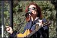 A person singing into a microphone

Description automatically generated
