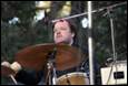 A person playing a drum

Description automatically generated