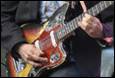 A person playing a guitar

Description automatically generated with medium confidence