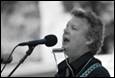 A person singing into a microphone

Description automatically generated