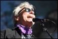 A person with sunglasses and a microphone

Description automatically generated with low confidence