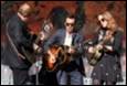 A group of people playing instruments

Description automatically generated with medium confidence
