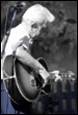 An old person playing a guitar

Description automatically generated with low confidence