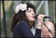 A person singing into a microphone

Description automatically generated