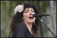 A person singing into a microphone

Description automatically generated