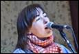 A person singing into a microphone

Description automatically generated