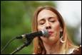 A person singing into a microphone

Description automatically generated
