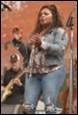 A person holding a microphone

Description automatically generated