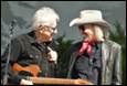 A person and person in cowboy hats

Description automatically generated