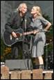 A person and person singing on stage

Description automatically generated
