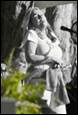 A person standing outside with her arms crossed

Description automatically generated