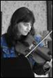 A person playing a violin

Description automatically generated
