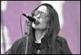 A person singing into a microphone

Description automatically generated