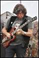 A person playing a guitar

Description automatically generated