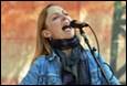 A person singing into a microphone

Description automatically generated