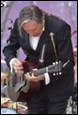 A person playing a guitar

Description automatically generated