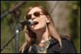 A person singing into a microphone

Description automatically generated