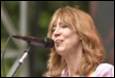 A person singing into a microphone

Description automatically generated