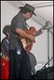A person playing a guitar

Description automatically generated