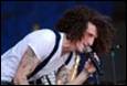 A person with curly hair singing into a microphone

Description automatically generated with medium confidence