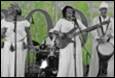 A group of women in white dresses playing instruments

Description automatically generated with low confidence