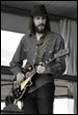 A person with long hair and beard playing a guitar

Description automatically generated with medium confidence