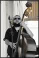 A person playing a bass

Description automatically generated with medium confidence