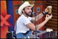A person in a cowboy hat playing guitar

Description automatically generated with medium confidence