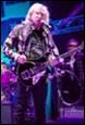 A person playing a guitar on stage

Description automatically generated with medium confidence