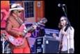 A picture containing clothing, microphone, concert, person

Description automatically generated