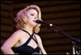 A person singing into a microphone

Description automatically generated