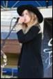 A picture containing clothing, microphone, person, human face

Description automatically generated